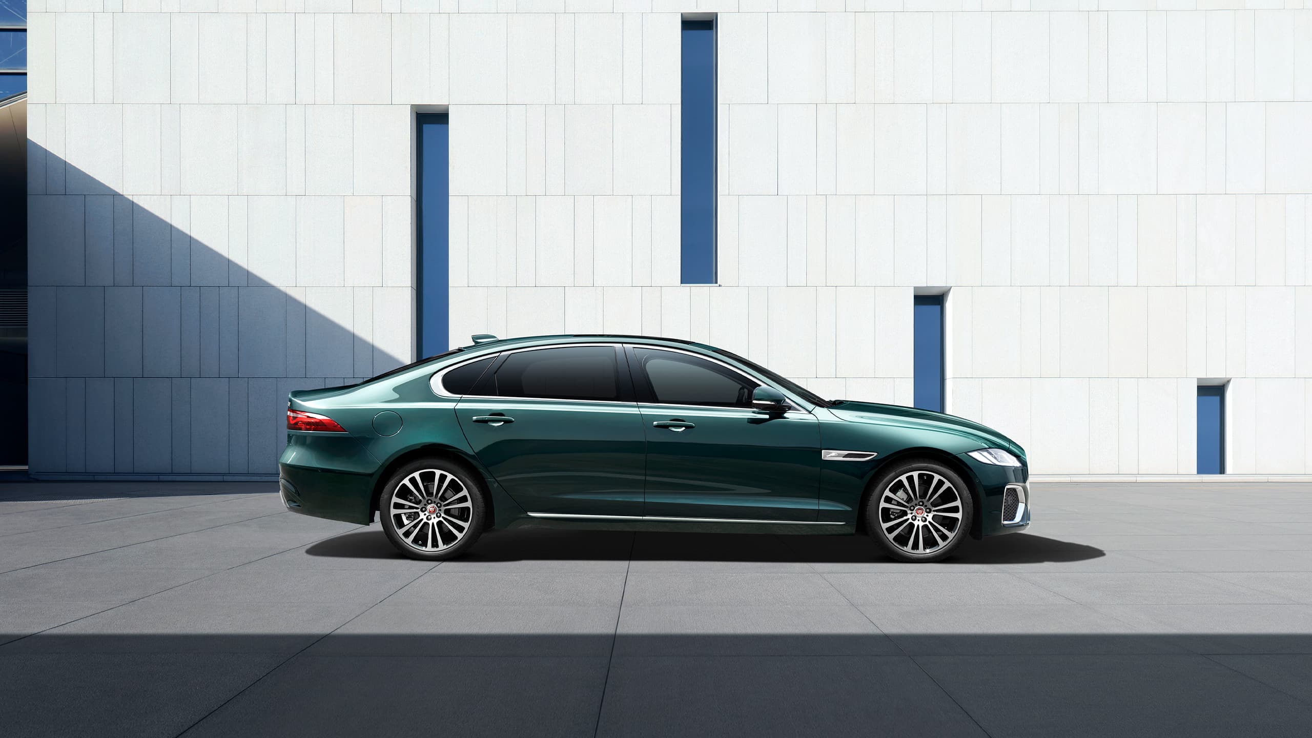 Jaguar parked in front of wall
